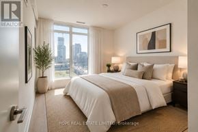Toronto (Waterfront Communities) condo for rent - A bedroom with a large bed and a view of the city.