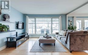 Georgina (Keswick South) apartment for rent - A living room with a grey couch, a coffee table, and a flat screen TV.