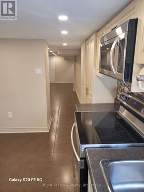 Toronto (Corso Italia-Davenport) triplex for rent - A kitchen with a black counter top and a stainless steel sink.