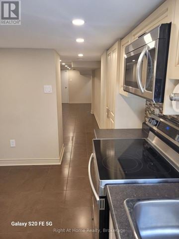Toronto (Corso Italia-Davenport) triplex for rent - A kitchen with a black counter top and a stainless steel sink.