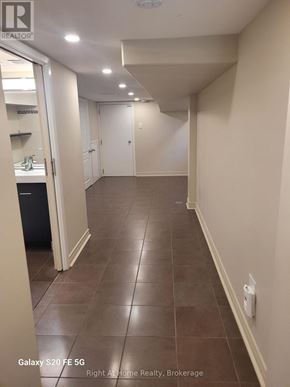 Toronto (Corso Italia-Davenport) triplex for rent - A hallway with tile flooring and white walls.