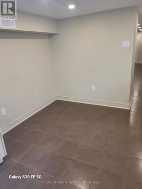 Toronto (Corso Italia-Davenport) triplex for rent - A room with tile flooring and a wall socket.