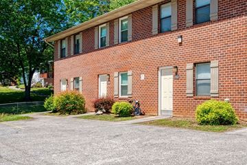 Knoxville apartment for rent - A red brick building with a white door and windows.