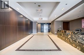 Burlington (Uptown) condo for rent - A hallway with a marble counter and a sign that says RE/MAX Escarpment Realty Inc.