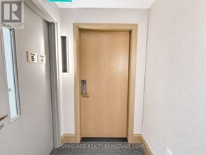 Vaughan (Vaughan Corporate Centre) condo for rent - A wooden door with a handle and a sign above it that says "B 4".