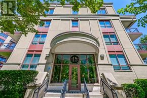 Toronto (Bayview Village) condo for rent - A building with a curved entrance and a balcony on the second floor.