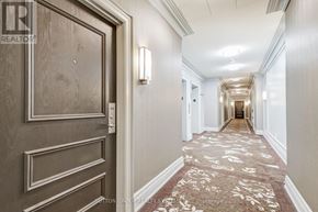 Toronto (Bayview Village) condo for rent - A hallway with a carpeted floor and a door on the left.