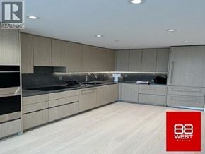 North Vancouver apartment for rent - A modern kitchen with wooden floors and cabinets.