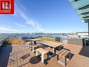 North Vancouver apartment for rent - A wooden deck with benches overlooking a body of water.