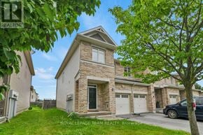 Ottawa townhouse for rent - A house with a tree in front of it.