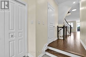 Ottawa townhouse for rent - A hallway with a wooden floor and white walls.