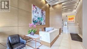 Toronto (Wychwood) condo for rent - A black leather chair sits in front of a reception desk with a white marble top.