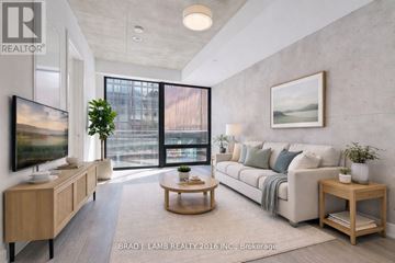 Toronto (Moss Park) condo for rent - A modern living room with a large window and a flat screen TV.