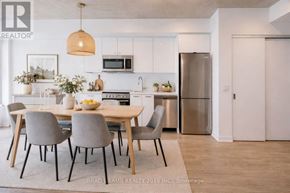 Toronto (Moss Park) condo for rent - A modern kitchen with a dining table set for four.