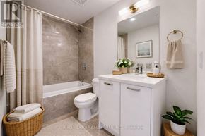 Toronto (Moss Park) condo for rent - A white bathroom with a toilet, sink, and shower.