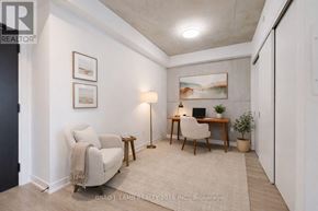 Toronto (Moss Park) condo for rent - A well-lit room with a desk, chair, and lamp.