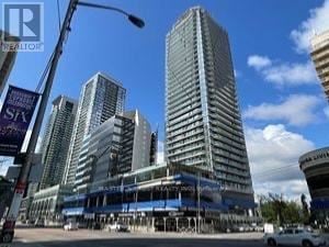 Toronto (Willowdale West) condo for rent - A tall building with a blue sky in the background.