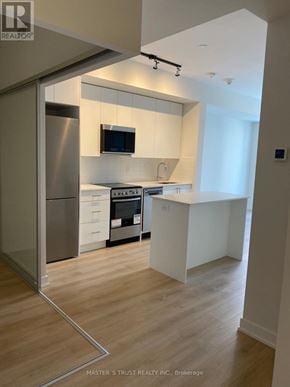 Toronto (Willowdale West) condo for rent - A kitchen with a refrigerator, microwave, and oven.