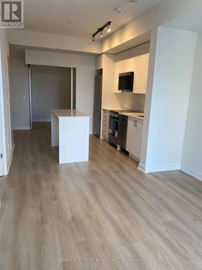 Toronto (Willowdale West) condo for rent - A kitchen area with a white cabinet and a microwave above it.