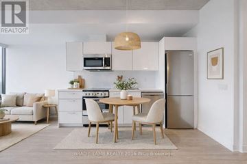 Toronto (Moss Park) condo for rent - A modern kitchen with a dining table set up.