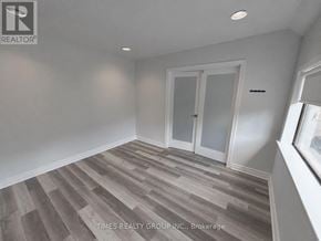 Toronto (Church-Yonge Corridor) multi-family for rent - A room with wooden flooring and white walls.