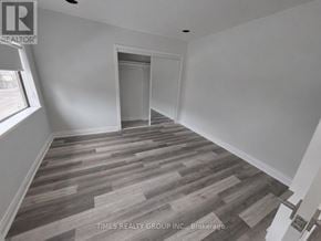 Toronto (Church-Yonge Corridor) multi-family for rent - A room with wooden flooring and a doorway leading to another room.