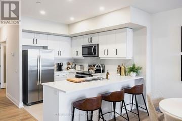 Kitchener house for rent - A modern kitchen with white cabinets and a large island.