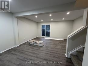 Ottawa townhouse for rent - A room with a grey carpet and a window with a view of the city.