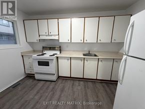 Ottawa townhouse for rent - A kitchen with white appliances and cabinets.