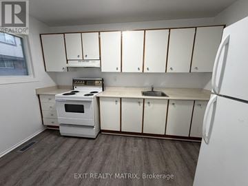 Ottawa townhouse for rent - A kitchen with white appliances and cabinets.