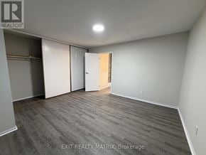 Ottawa townhouse for rent - A room with a grey carpet and a white door.