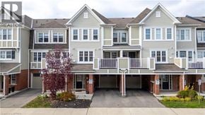 Cambridge townhouse for rent - A large, multi-story residential building with a garage and a tree in front.