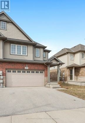 Thorold (Confederation Heights) townhouse for rent - A house with a garage is located in a residential area.