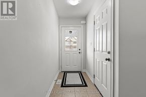 Thorold (Confederation Heights) townhouse for rent - A hallway with a door and a brokerage logo.