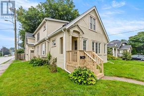 St. Catharines (Downtown) duplex for rent - A house with a well-maintained lawn and a clear sky in the background.
