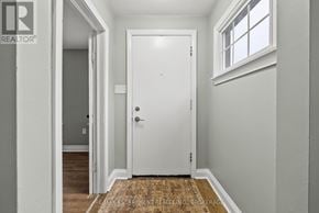 St. Catharines (Downtown) duplex for rent - A white door is in the middle of a hallway.