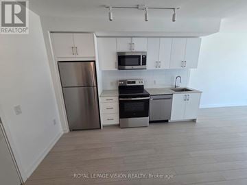 Toronto (Humber Heights) condo for rent - A kitchen with white cabinets and stainless steel appliances.
