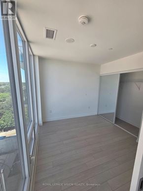 Toronto (Humber Heights) condo for rent - A room with a sliding glass door and a wood floor.