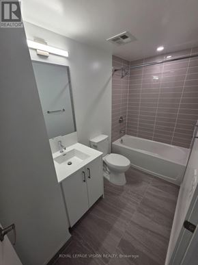 Toronto (Humber Heights) condo for rent - A white bathroom with a toilet, sink, and bathtub.