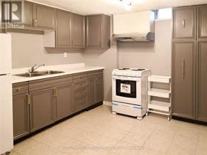 Mississauga (Lisgar) apartment for rent - A kitchen with a white fridge, a white stove, and brown cabinets.