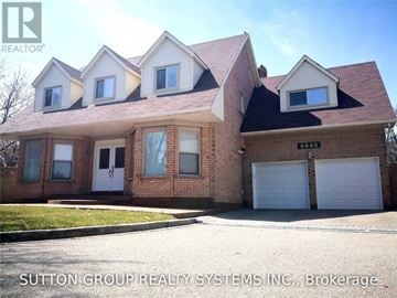 Mississauga (Lisgar) apartment for rent - A house with a brick facade and a white garage door is for sale.