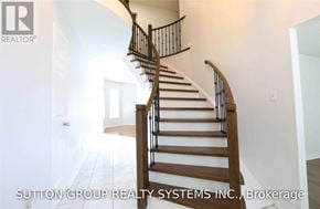 Mississauga (Lisgar) apartment for rent - A staircase with a wooden handrail and white walls.