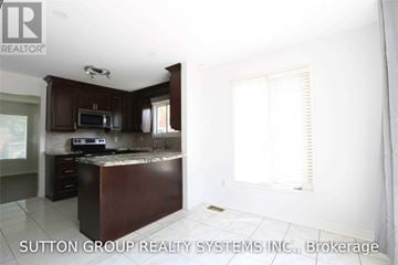 Mississauga (Lisgar) apartment for rent - A kitchen with dark wood cabinets and a white ceiling.