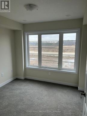 Thorold (Hurricane/Merrittville) townhouse for rent - A room with a large window overlooking a construction site.