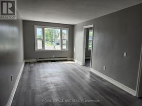 Welland (Welland Downtown) multi-family for rent - A room with a large window and a door is for sale.
