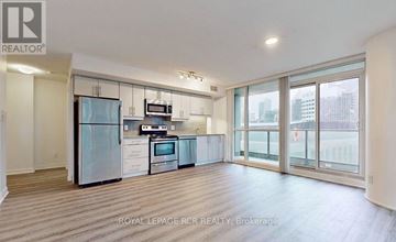Toronto (Waterfront Communities) condo for rent - A kitchen with a refrigerator, microwave, oven and sink.