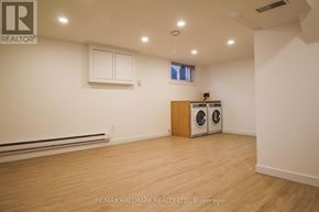 Toronto (South Riverdale) townhouse for rent - A room with a washer and dryer in it.