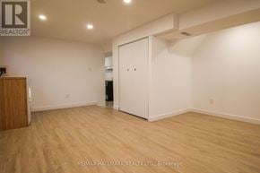 Toronto (South Riverdale) townhouse for rent - A room with a wooden floor and a white door.