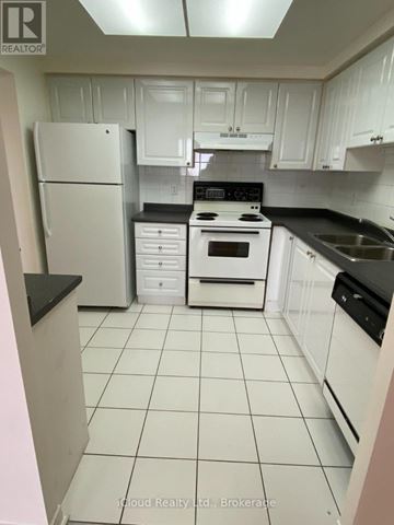 Mississauga (Cooksville) condo for rent - A kitchen with white cabinets and appliances.
