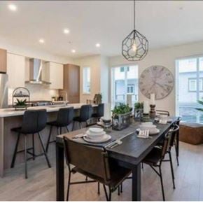Langley townhouse for rent - A modern kitchen with a dining table set for four.